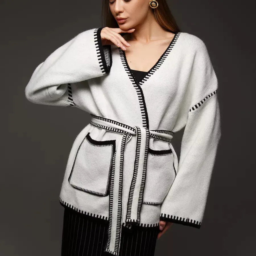 Lace-up front knitted cardigan in camel colour showing loose mid-length design and long sleeves