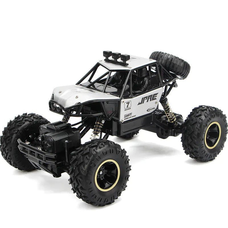 Black and silver remote control climbing cars with 2.4G wireless controller on a rough surface.