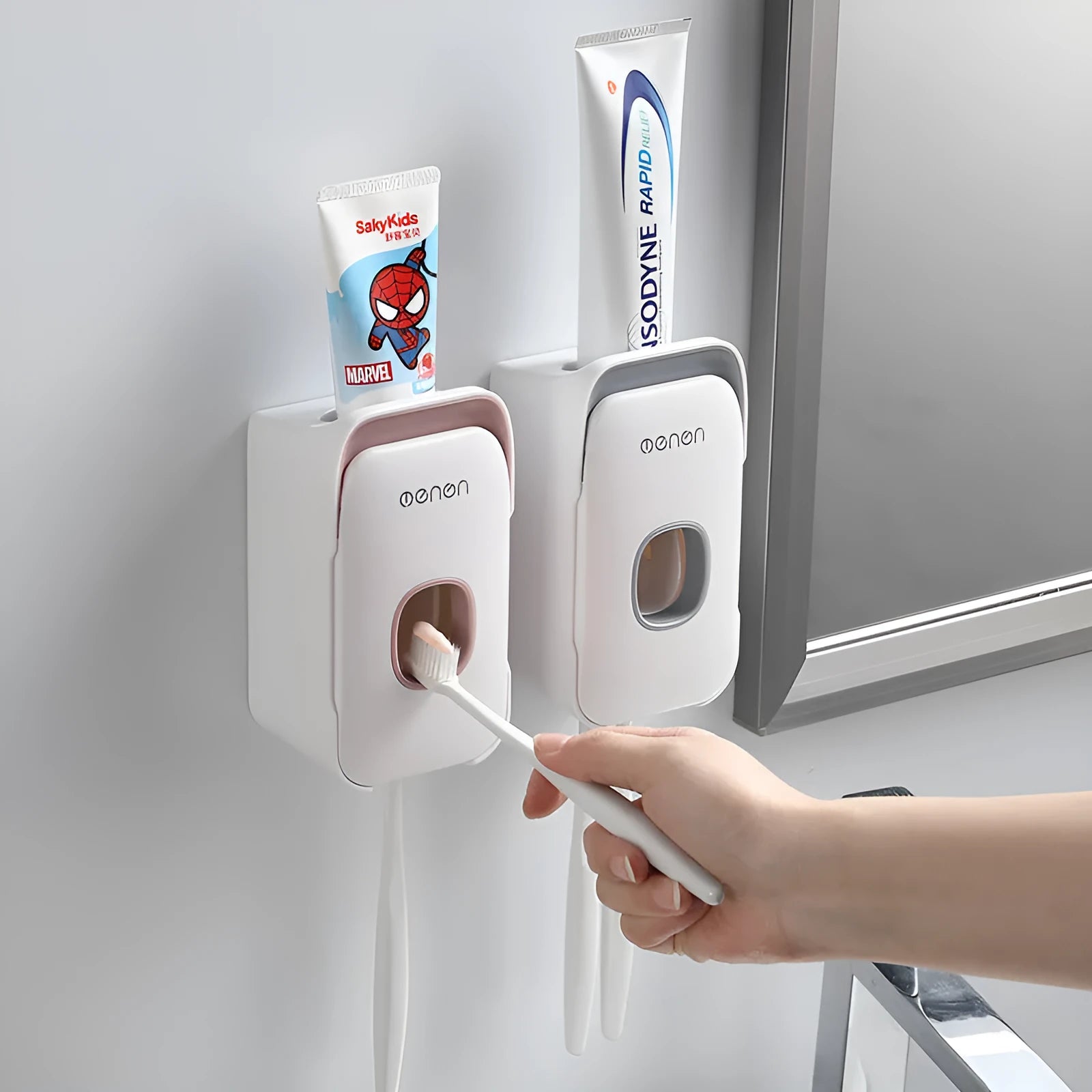 Automatic touchless toothpaste dispenser in blue colour mounted on a bathroom wall.