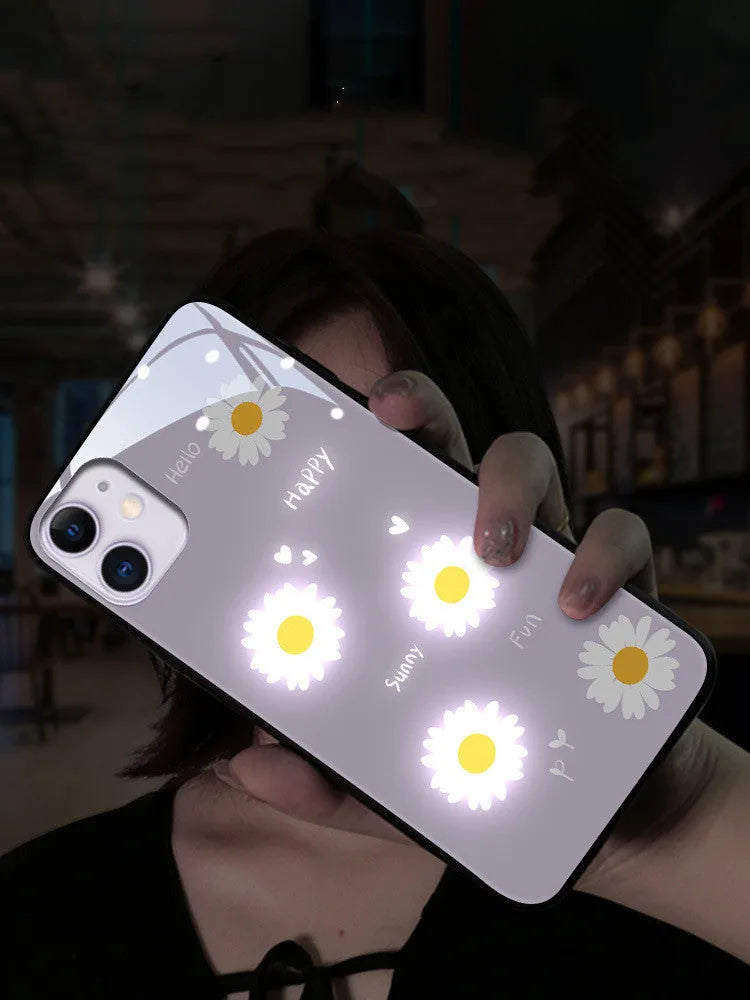 White luminous phone case with painted daisy design for Apple iPhone, showing voice-activated light feature.