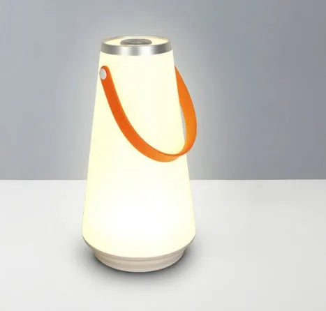 White rechargeable LED bedside night light with adjustable warm glow on wooden table