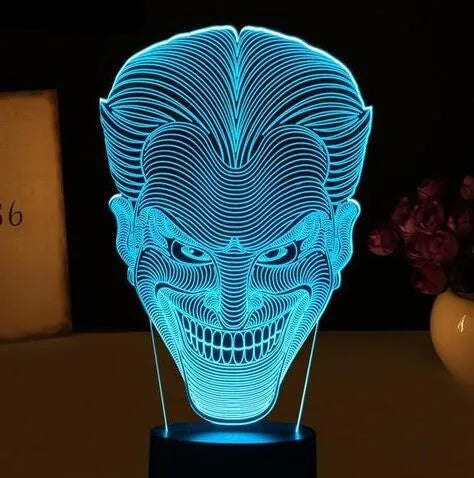 USB-powered 3D acrylic LED table lamp showing seven colour options on a desk