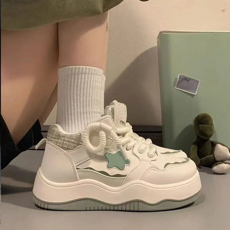 Women's green patent leather platform sneaker with front lace-up design and round toe