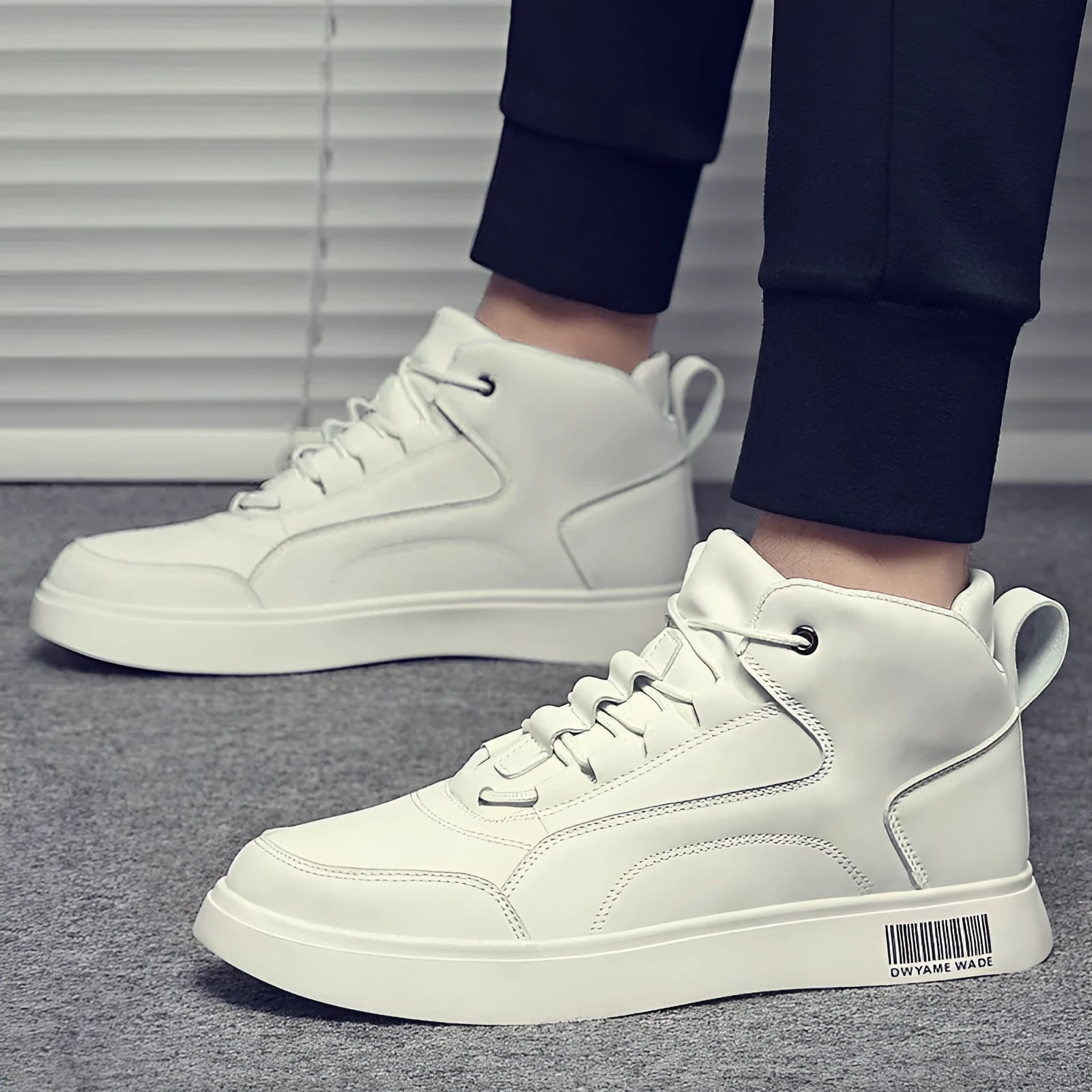Men's white mid-top casual shoes with round toe, rubber sole, and front lace-up design on a plain background