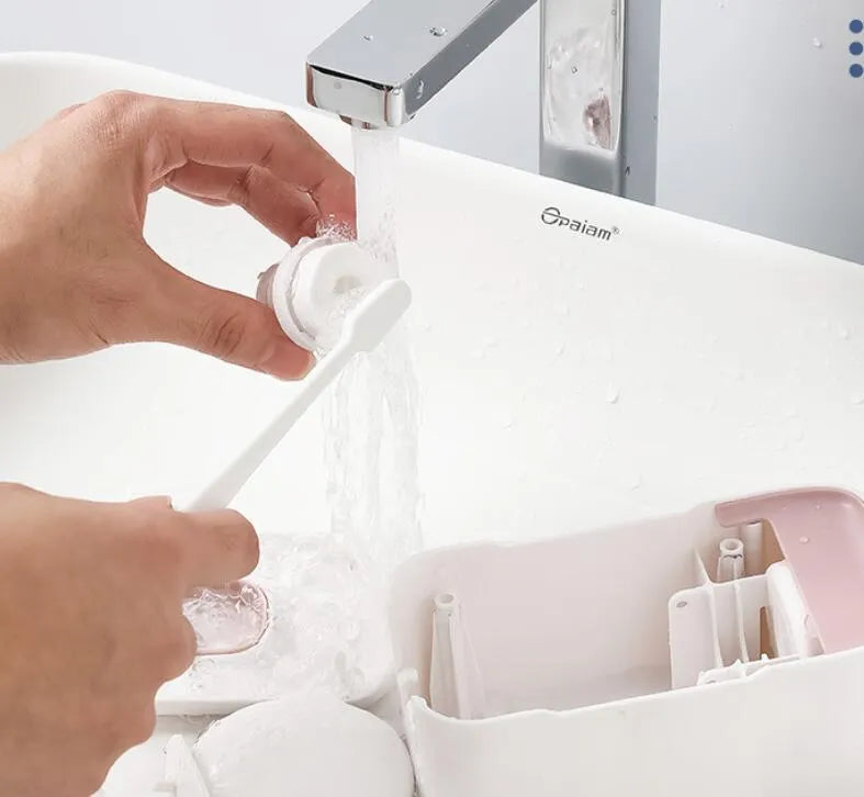 Automatic touchless toothpaste dispenser in blue colour mounted on a bathroom wall.