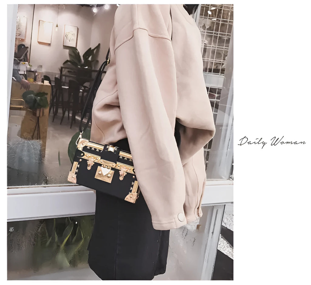 Black PU hard-sided women's shoulder bag with flap closure and decorative rivets