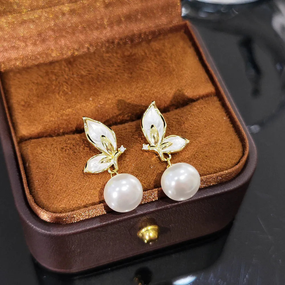 Pair of simple style butterfly earrings for women with electroplated copper construction.