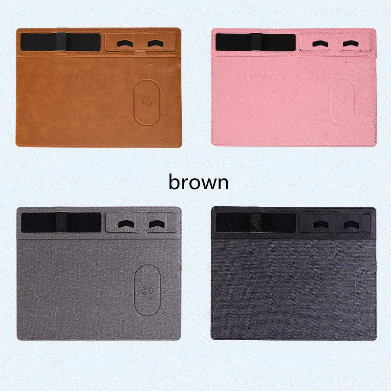 Pink wireless charging mouse pad with phone holder on a desk, showing USB cable connection