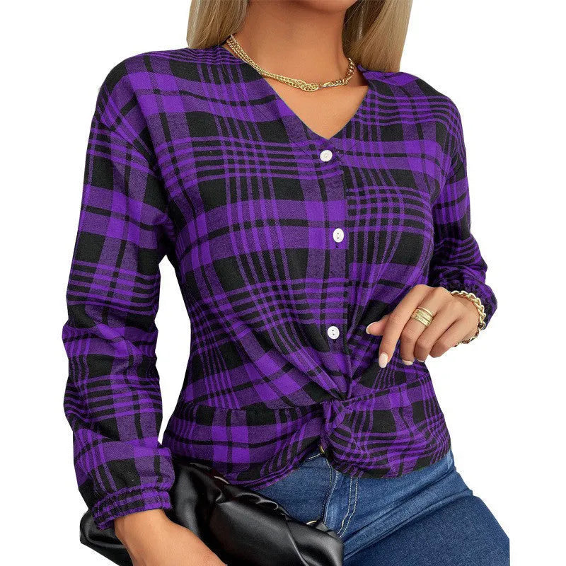 Woman wearing a loose-fitting purple, grey, and red plaid casual shirt with regular sleeves.