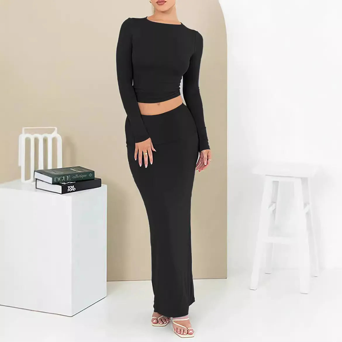 Women's black slim fit polyester two-piece suit with three-quarter sleeve top and long skirt.