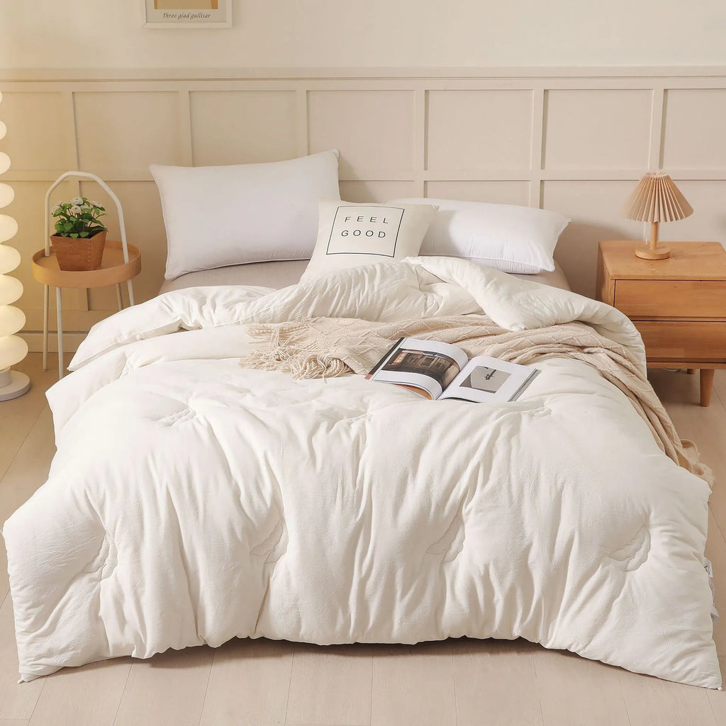 A pure cotton soybean fibre airable quilt in grey, shown with a zipper detail, on a bed.