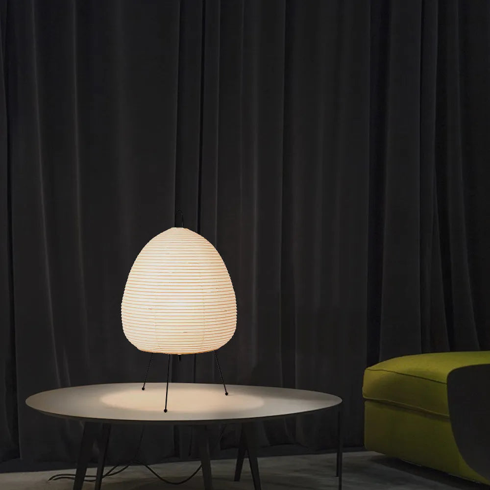 Japanese style rice paper table lamp with aluminium body and decorative shade on wooden surface