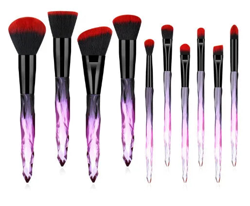 Ten crystal-handle foundation makeup brushes with synthetic bristles laid out flat