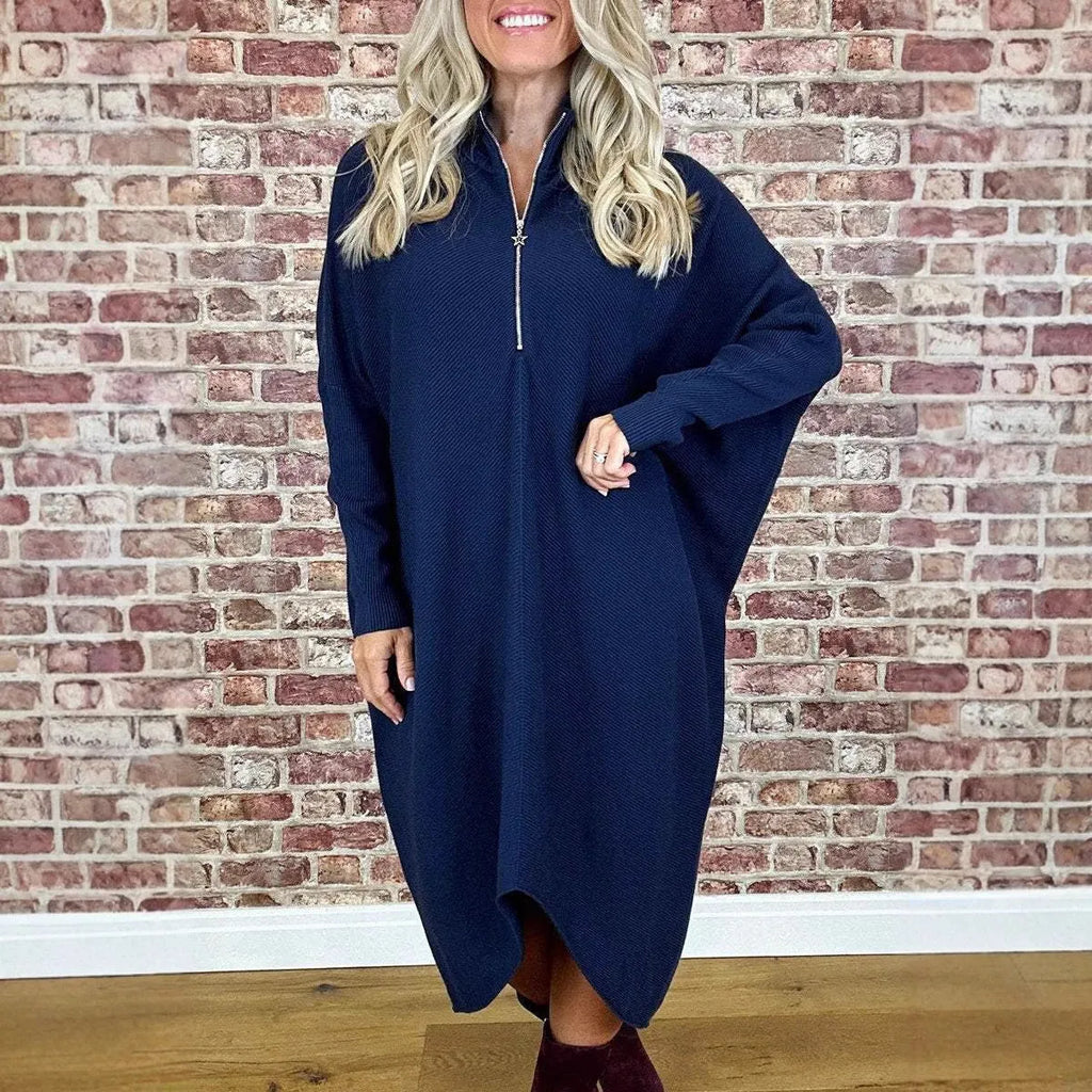 Women's solid colour loose knitted dress with raglan sleeves, shown in dark green.