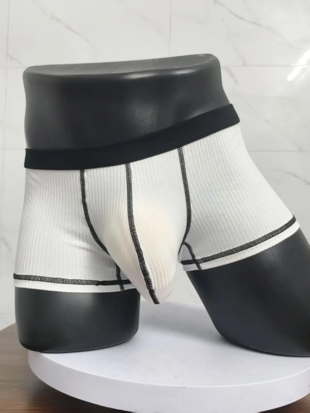 Men's solid colour boxer shorts on a white background, showing thin breathable fabric.