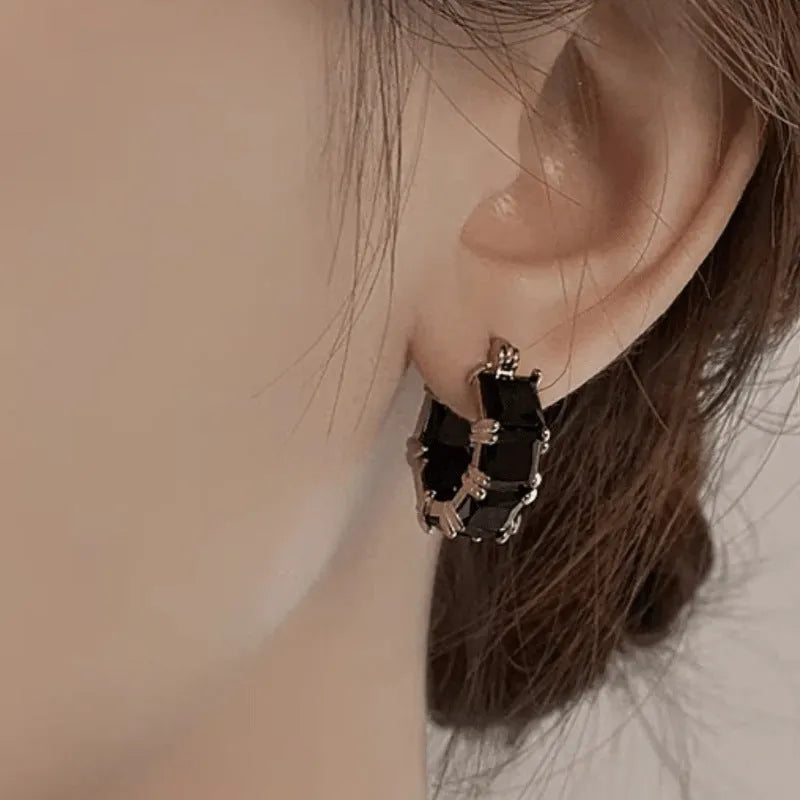 Geometric U-shaped earrings with round zircon crystals in black, pink or white with gold electroplating