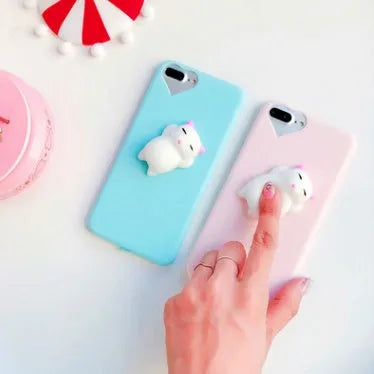 Soft pink TPU iPhone case with a raised white 3D cartoon cat design on the back.