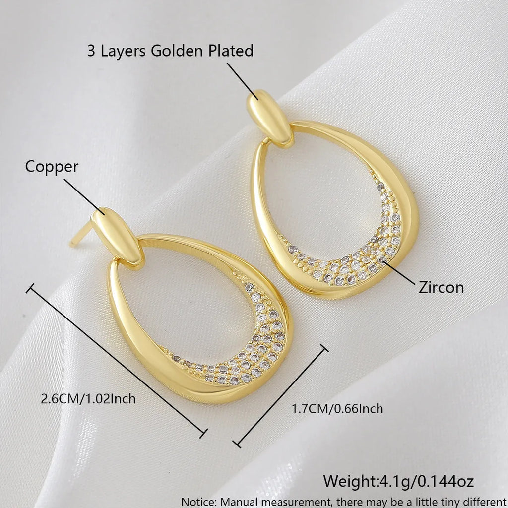 Women's yellow gold geometric drop earrings with copper electroplated finish measuring 2.6cm by 1.7cm