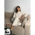 Women's white floral print lounge suit with bell sleeve top and wide leg trousers