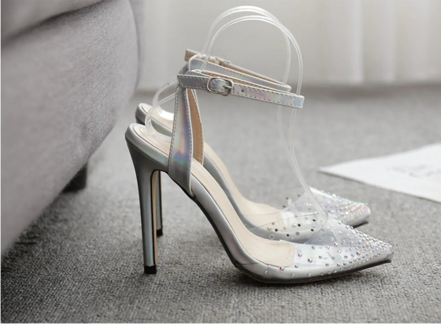 Women's pointed toe diamond sandals with stiletto heels on a white background.