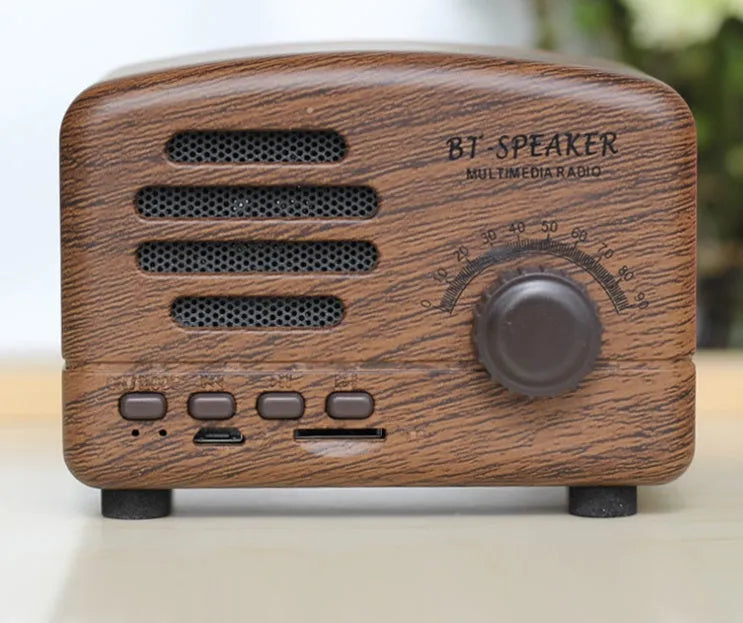 Vintage wood Bluetooth speaker in pink, black, and wood grain colours showing compact 93mm design