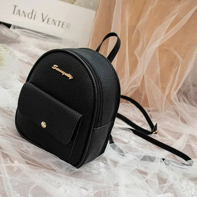 Compact black PU women's shoulder bag also worn as a small backpack, showing zipper closure.