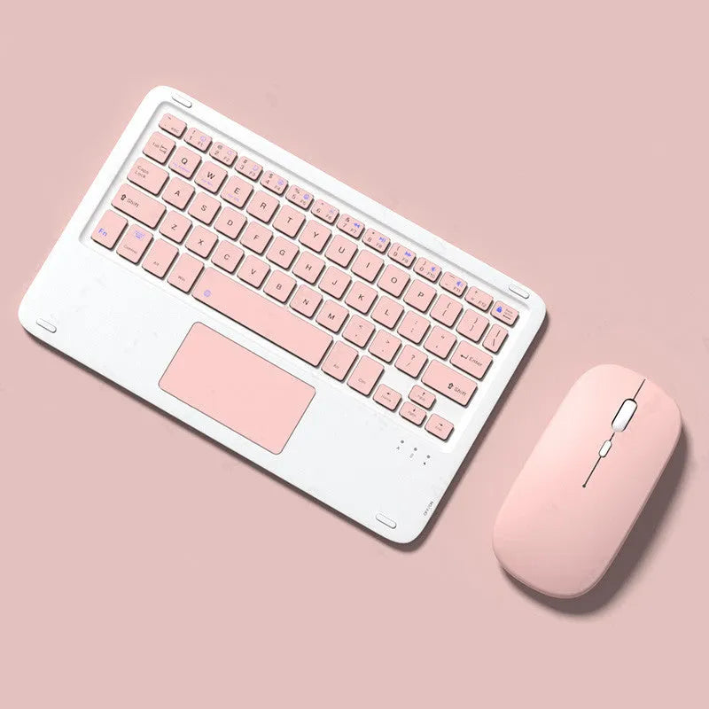 Pink wireless Bluetooth keyboard and mute mouse with USB charging cable on a desk