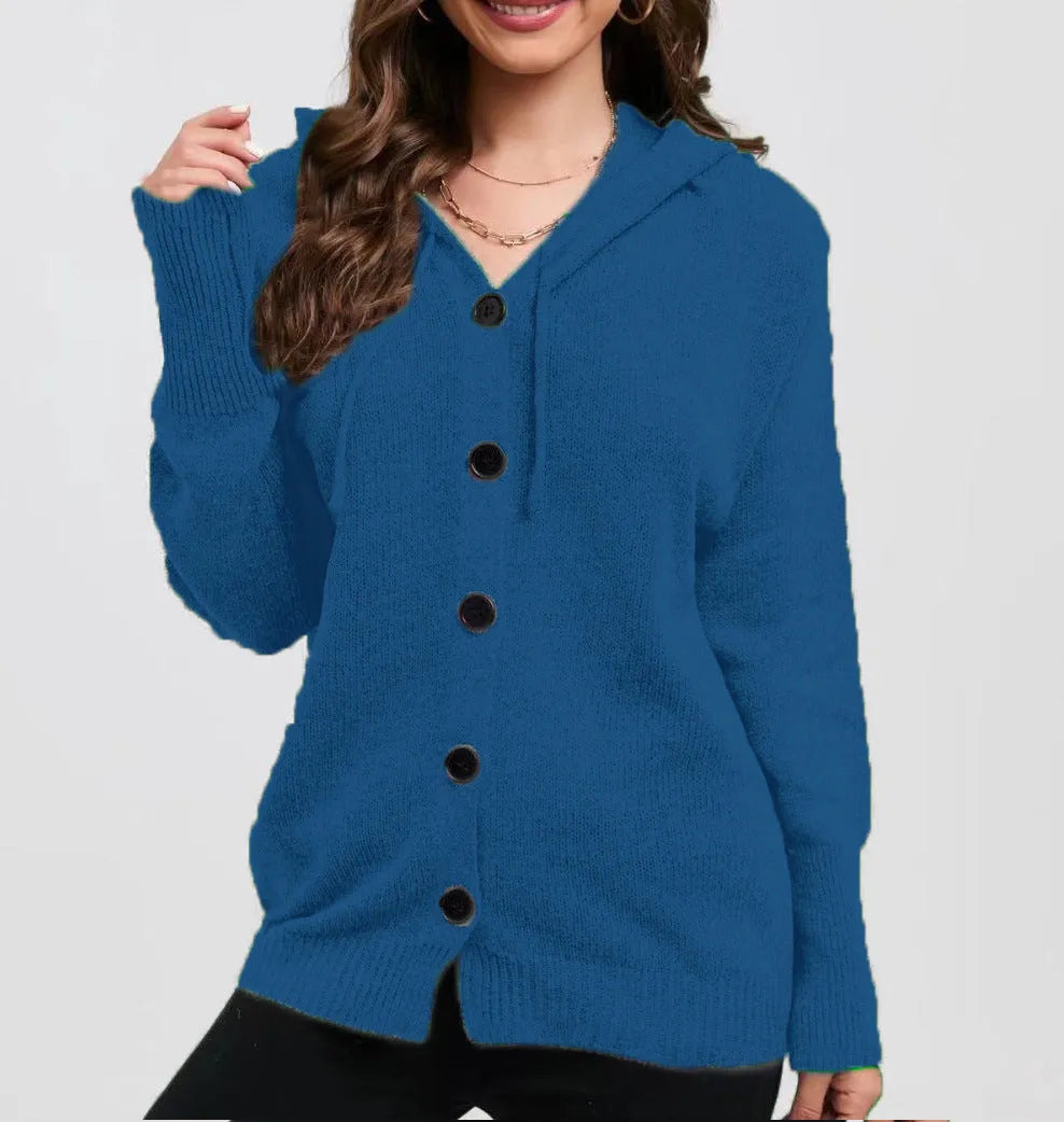 Woman wearing a thick army green zip-up hooded cardigan sweater with a loose fit.