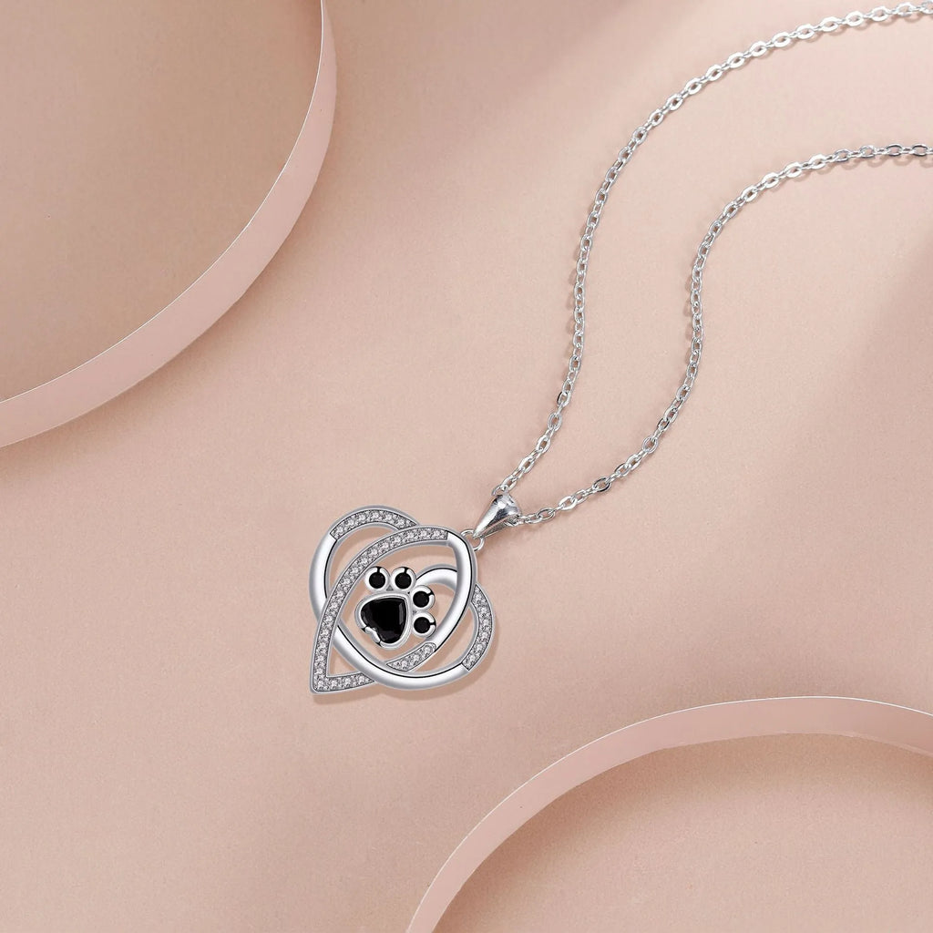 Silver tone dog and cat paw print necklace with cross chain design