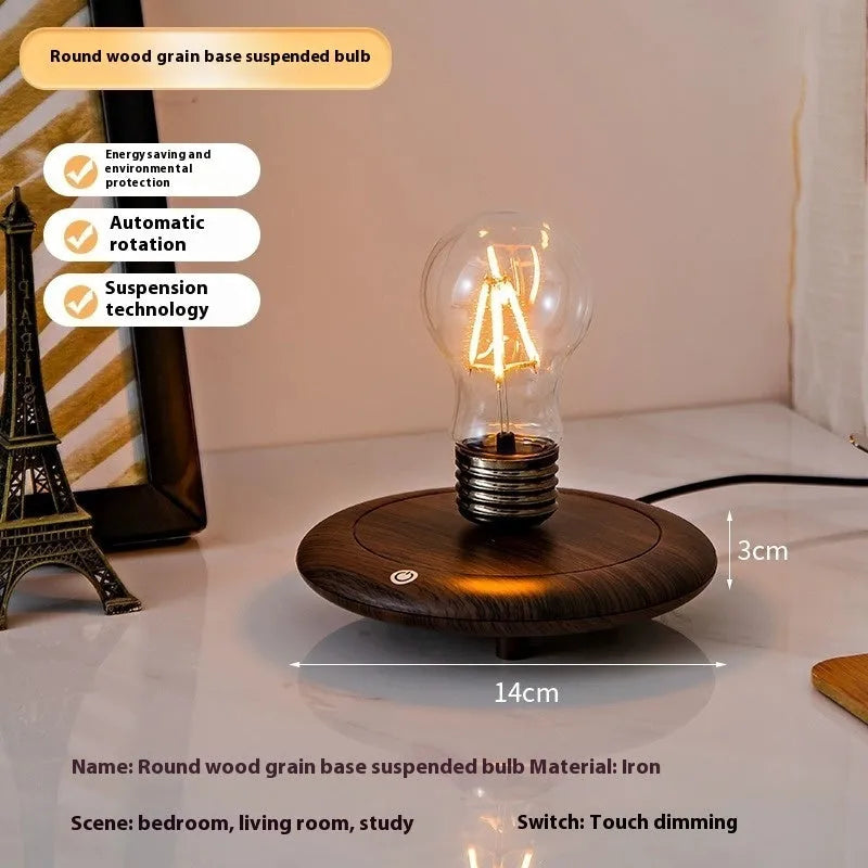 Iron art suspension bulb night lamp on black wood grain base measuring 11cm