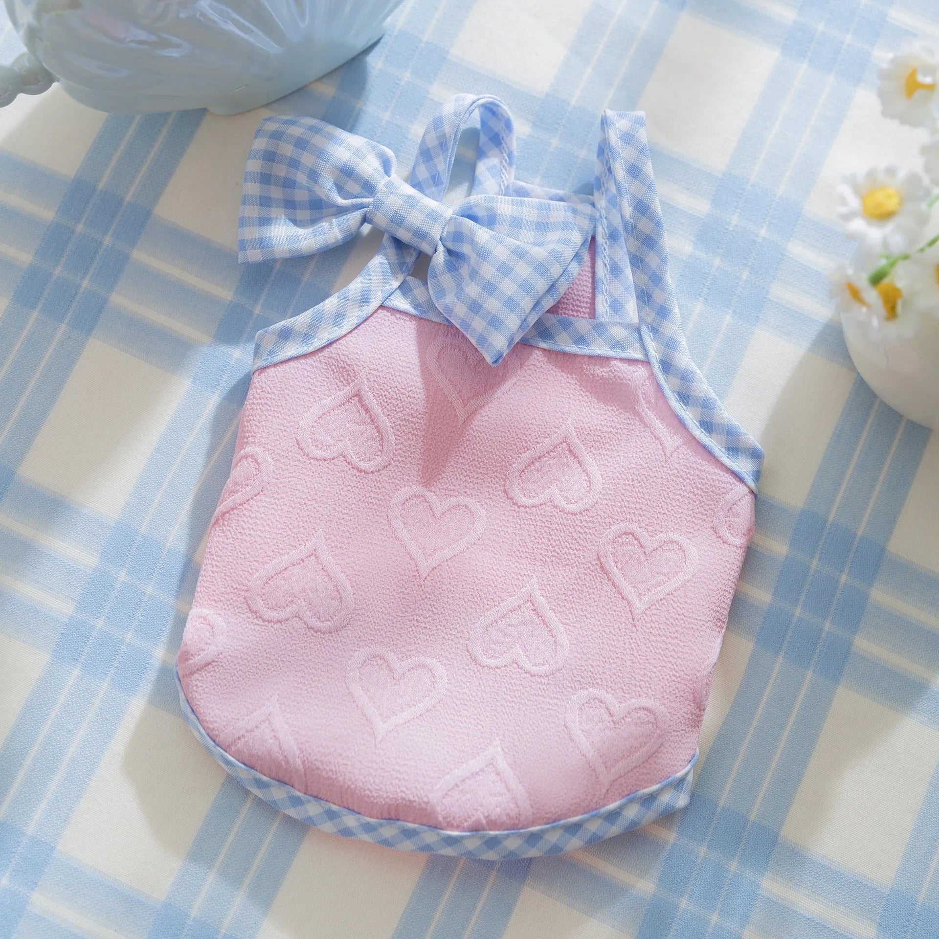 Small dog wearing heart relief texture bow suspenders vest in Bondi Blue colour