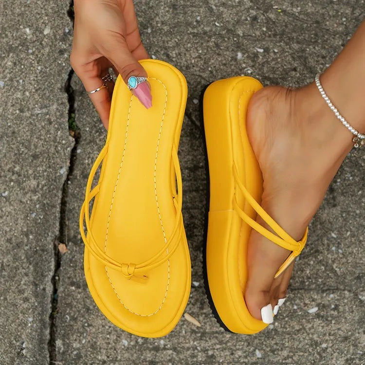 A pair of thick-soled herringbone pattern flip-flops in one of six colours on a plain background.