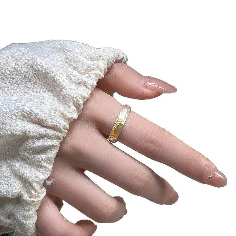 Geometric xiangyun pattern open mouth ring in silver electroplated finish on white copper.