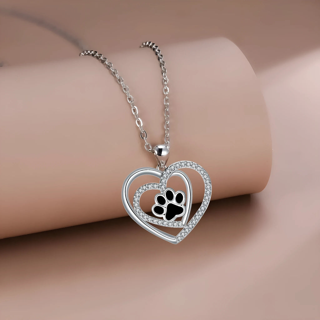 Women's copper necklace with dog paw print pendant and heart charm on cross chain