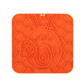 Silicone pet licking mat with suction cup on a tiled floor, featuring a slow food surface for dogs and cats