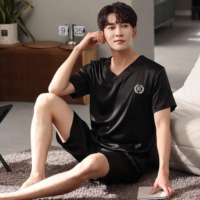 Man wearing a loose grey ice silk short-sleeve pajama shirt and matching shorts.