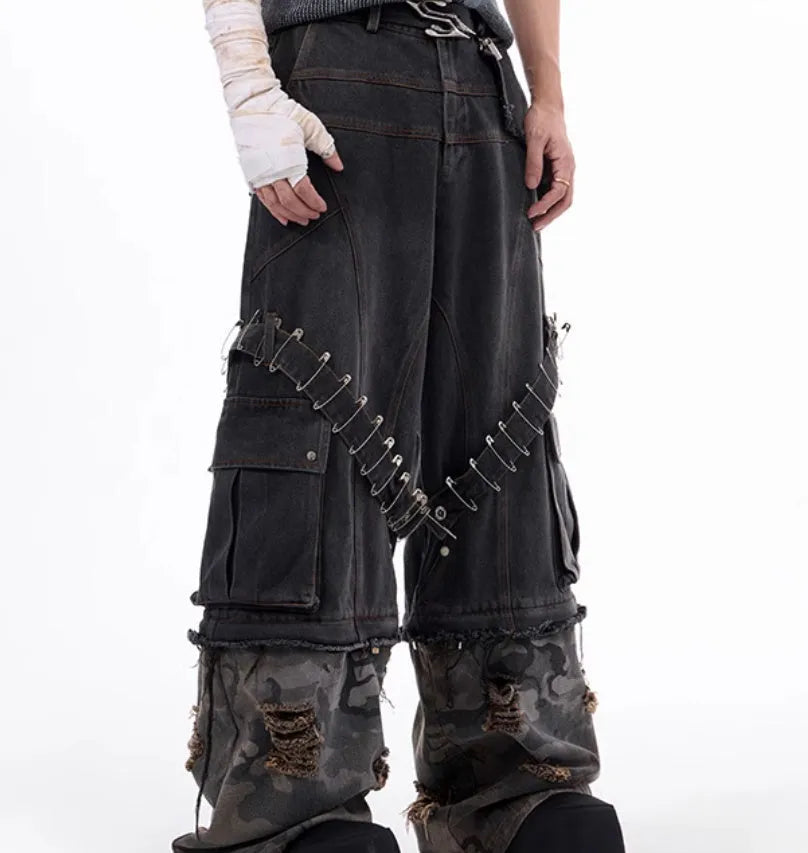 Men's grey camouflage jeans with splicing panel design and decorative pin and ribbon details