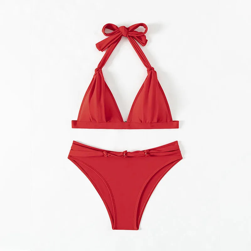 Red women's lace-up halterneck bikini set with high-cut shorts on a mannequin