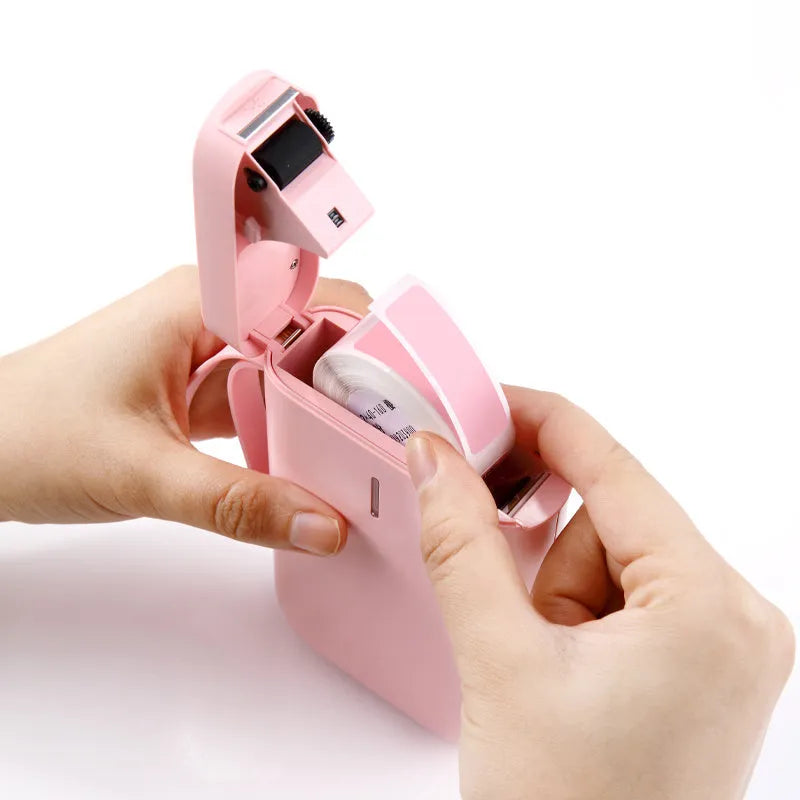 D11 Bluetooth-compatible portable label printer in black, white, pink, or green.