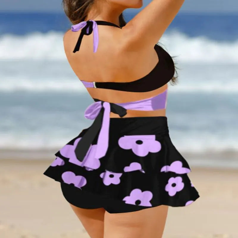 Women's purple bikini swimsuit with matching skirt showing high-waisted lace-up back design