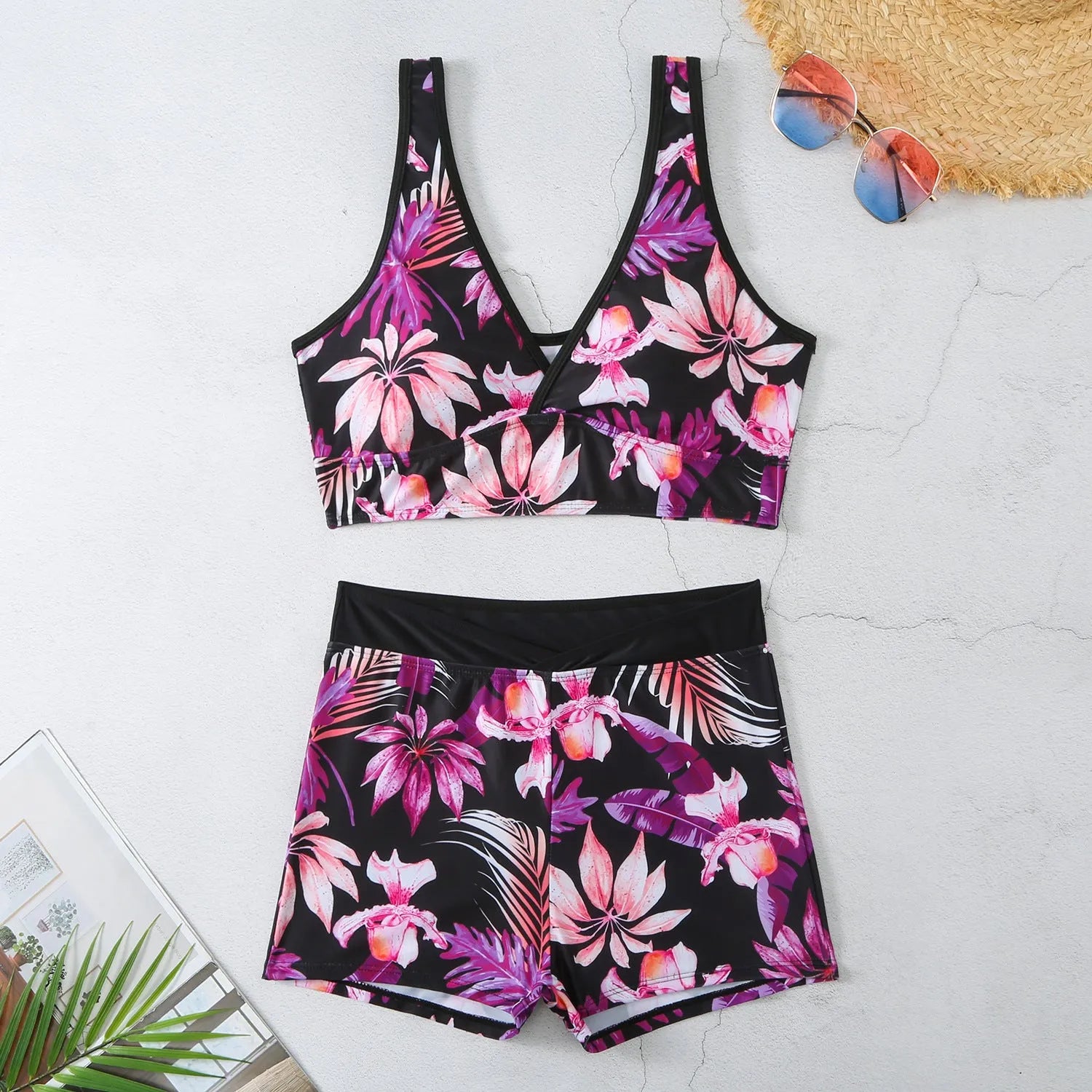 Women's two-piece swimsuit set with sleeveless top and printed boxer-style bottoms in a multi-colour pattern.
