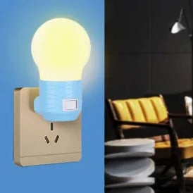 Plug-in bedside baby night light in white, blue, or pink shell with round design on a table