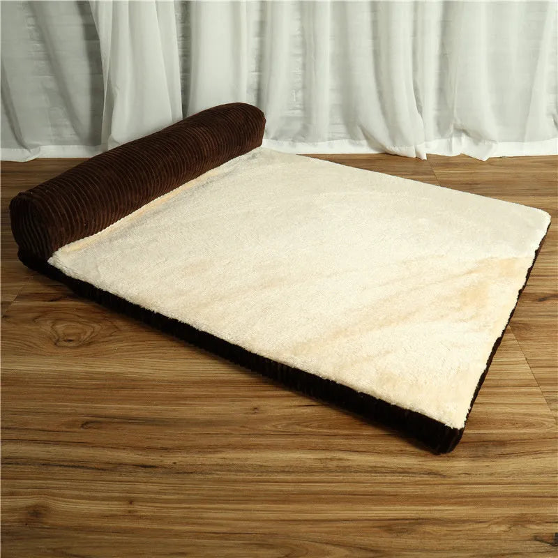 Corduroy dog sofa bed in grey, showing high sides and non-slip base, placed on a wooden floor.