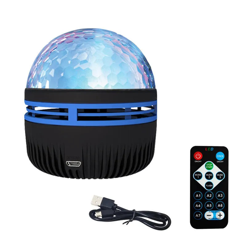 Compact USB-powered LED lamp projecting rotating colourful stars and galaxies onto a dark wall.
