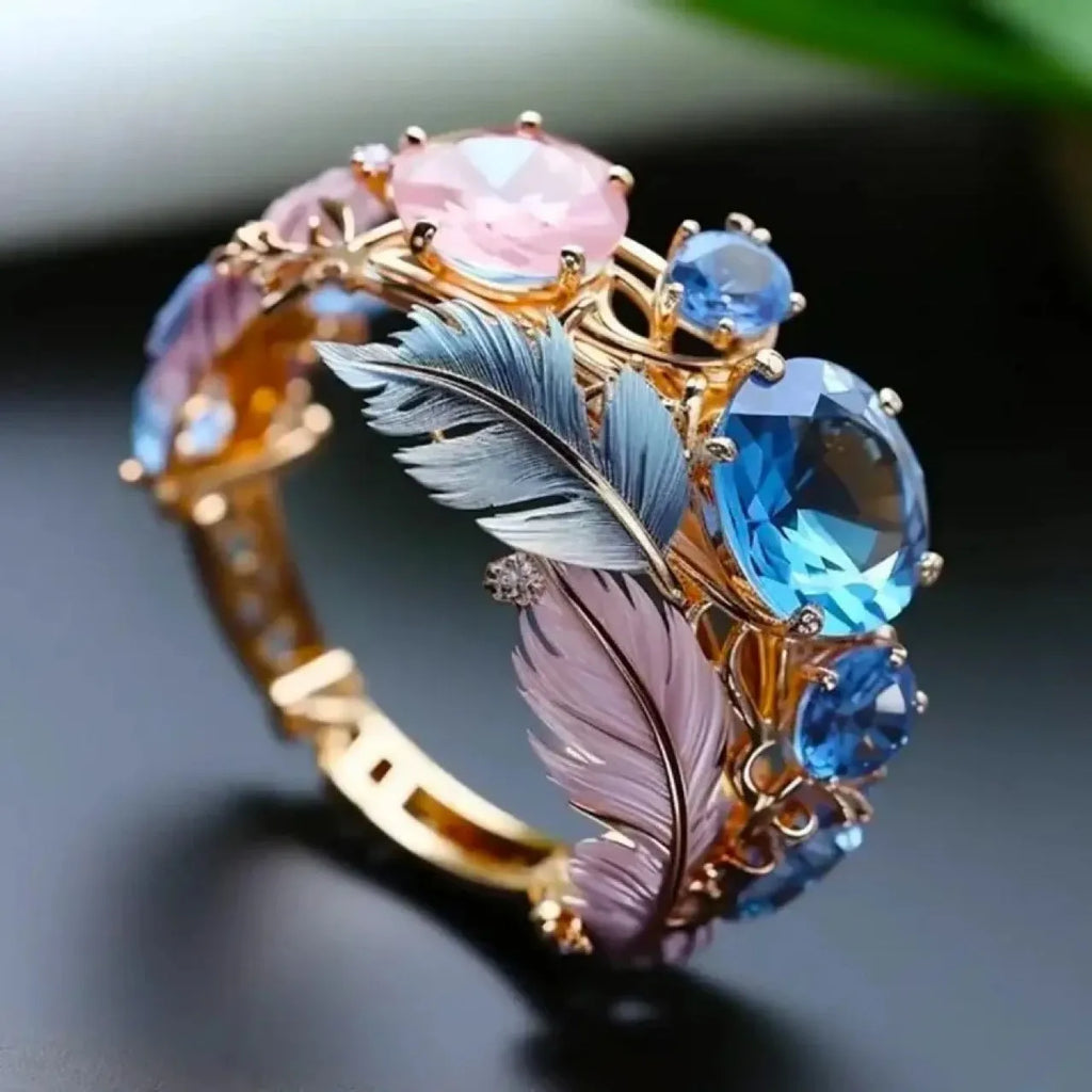 Gold colour embossed feather brass ring with zircon inlay detail showing textured surface