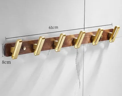 Black walnut bathroom clothes hook row with brass-finished aluminium hooks in perforated mounting design