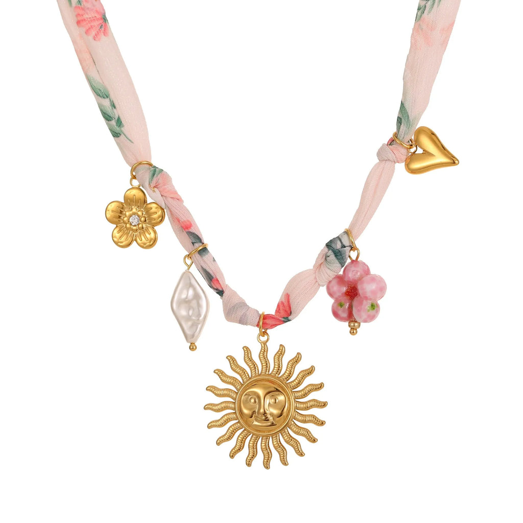 Geometric sun pendant on a stainless steel necklace with an 18K gold electroplated finish.