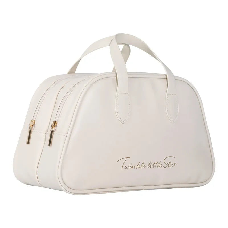 Leather travel toiletry bag in caramel mocha colour showing storage compartments and decorative letter details