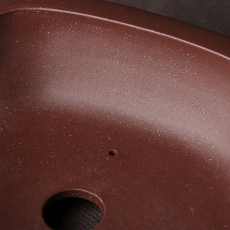 Handmade plain purple clay bonsai pot measuring 25 by 20 by 7 centimetres.