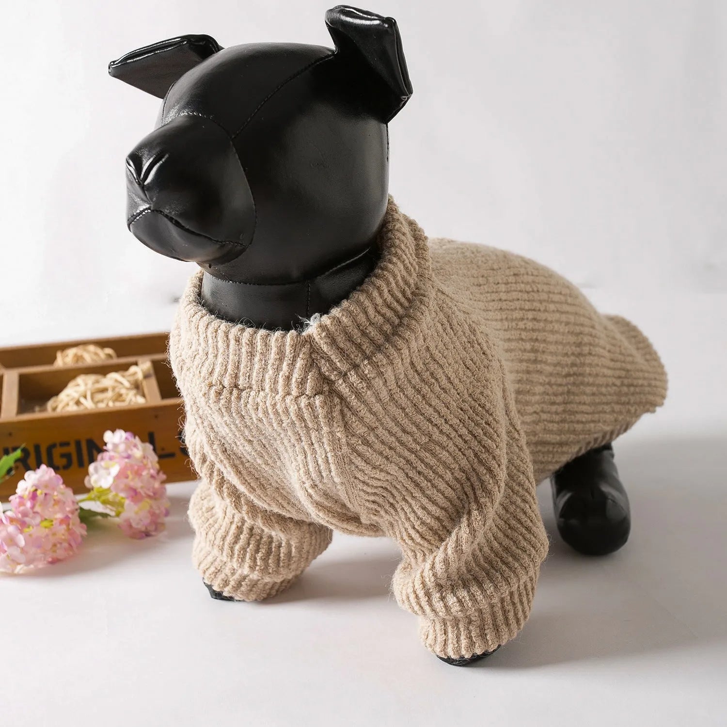 Brown cloth pullover dog sweater on a small breed dog.